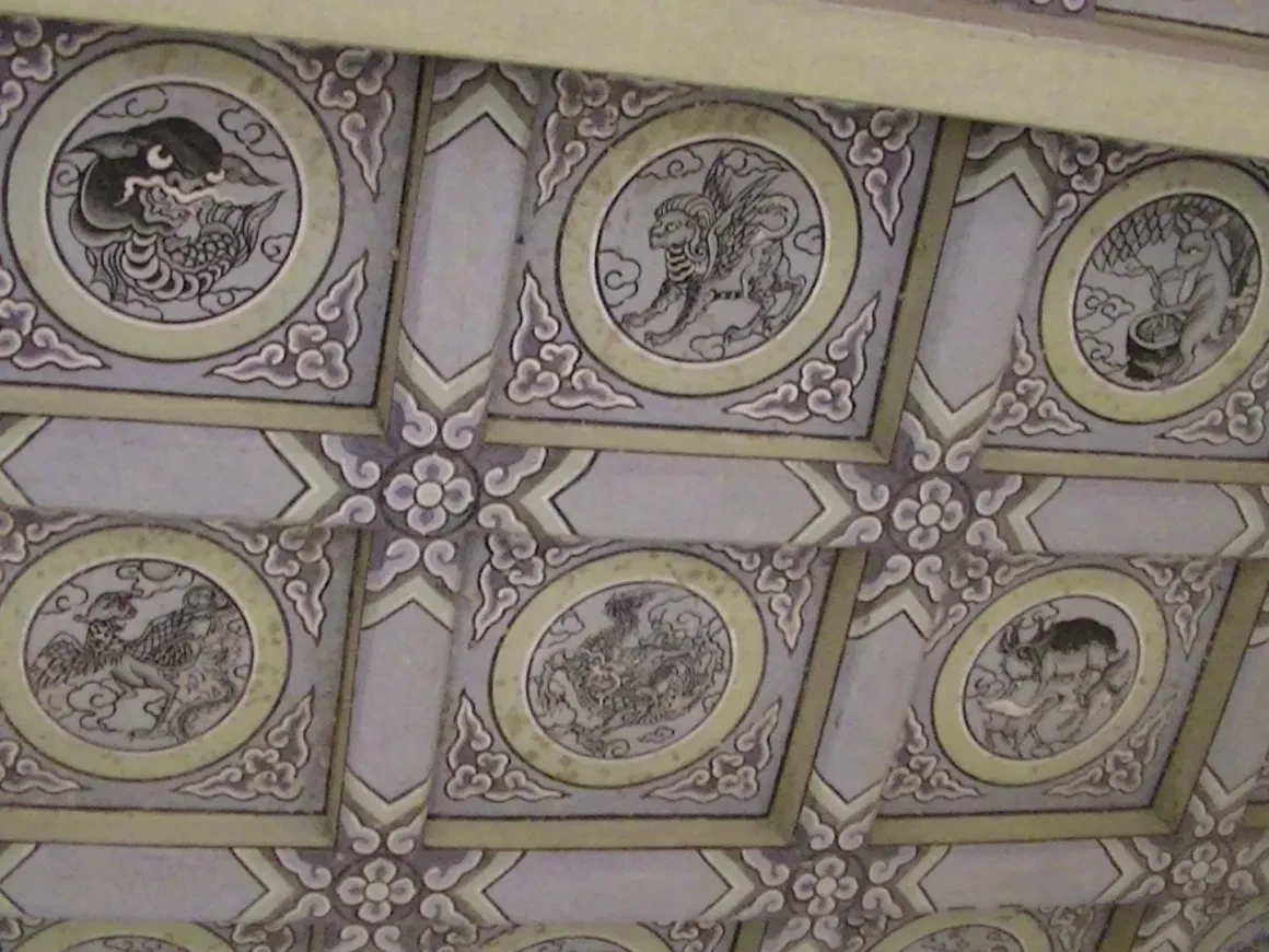 Ornate temple ceiling with mythological creature medallions