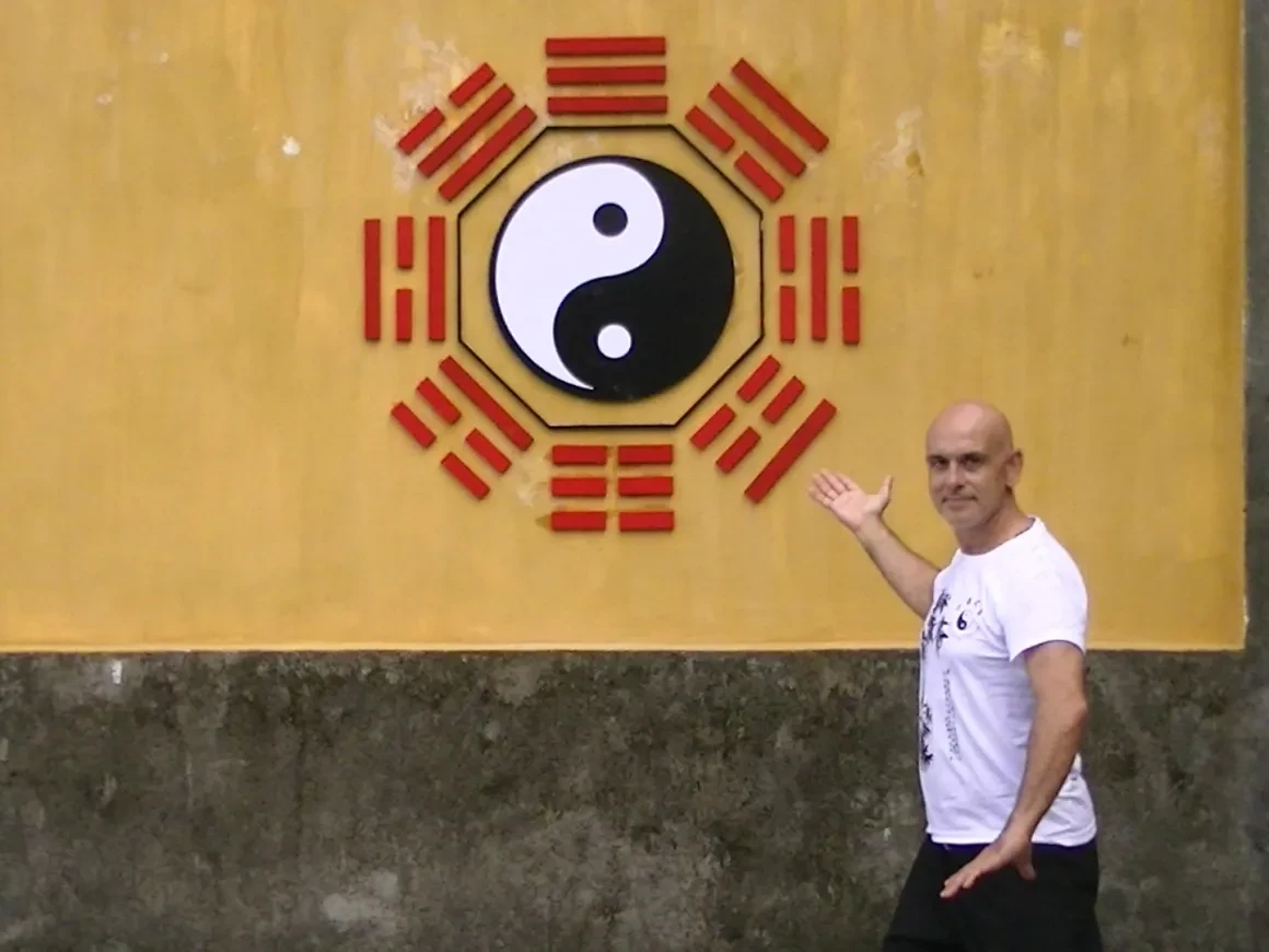 Tony Garcia at the yin-yang and I Ching trigrams wall