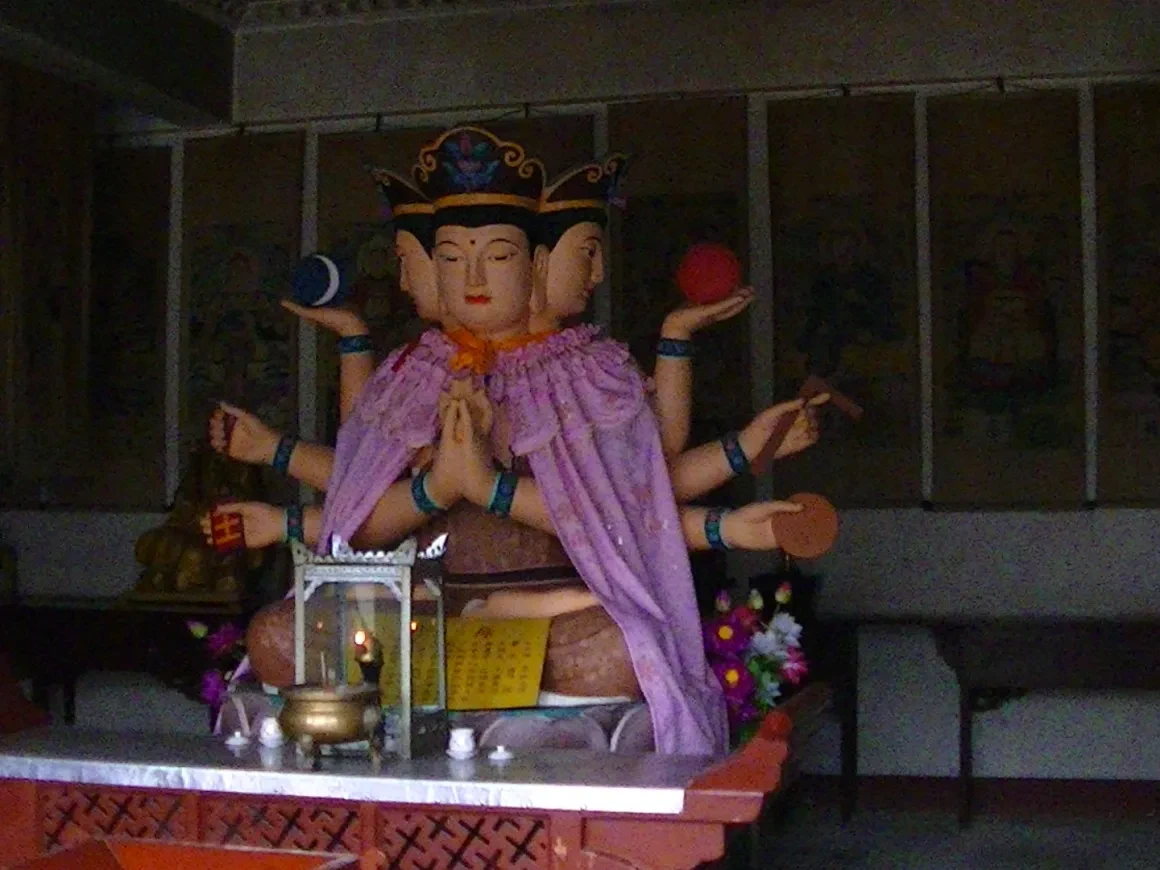 Multi-armed deity statue at a Chinese temple shrine