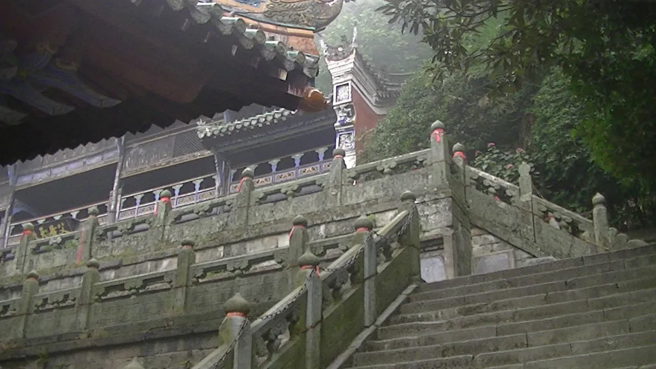 Ancient stone stairway leading up to a misty Wudang Mountain temple