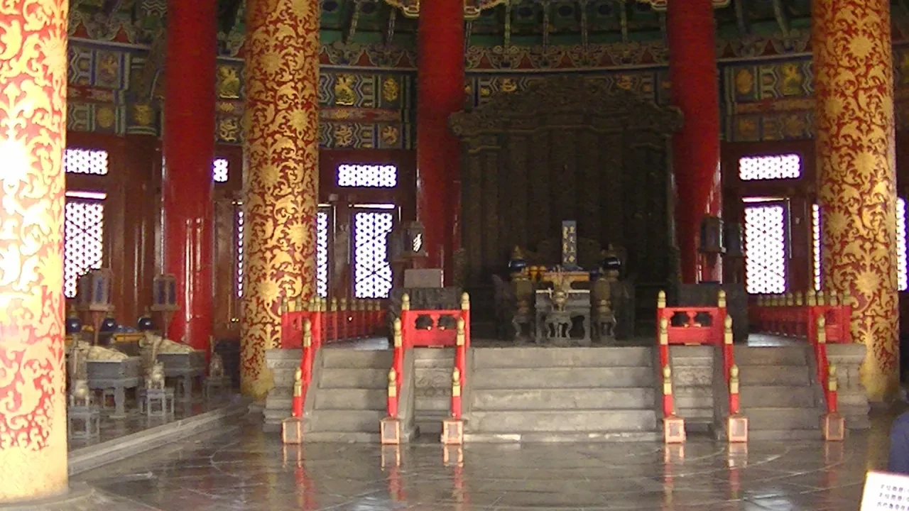 Ornate imperial hall interior with red and gold pillars and altar steps