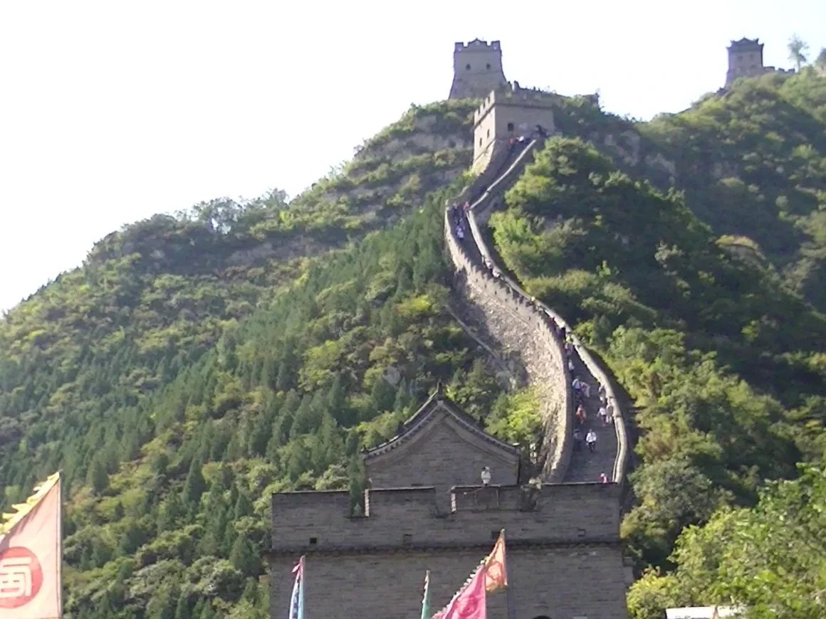 The Great Wall winding over green mountains