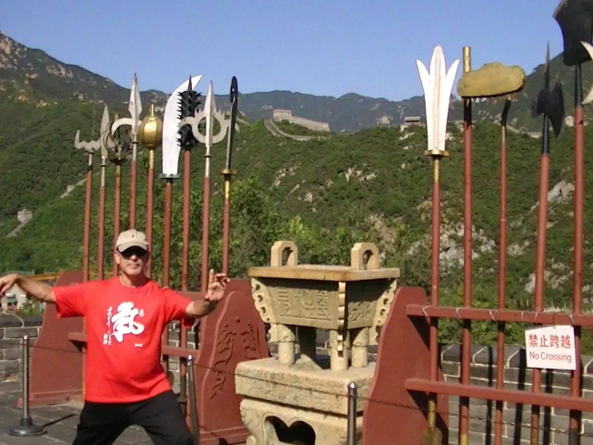 Tony Garcia at the Great Wall with traditional weapons display