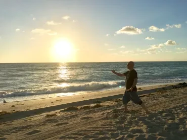 Tony Garcia practicing Tai Chi on the beach at sunrise