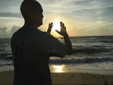 Tony Garcia channeling Chi/Qi energy at the ocean at sunset